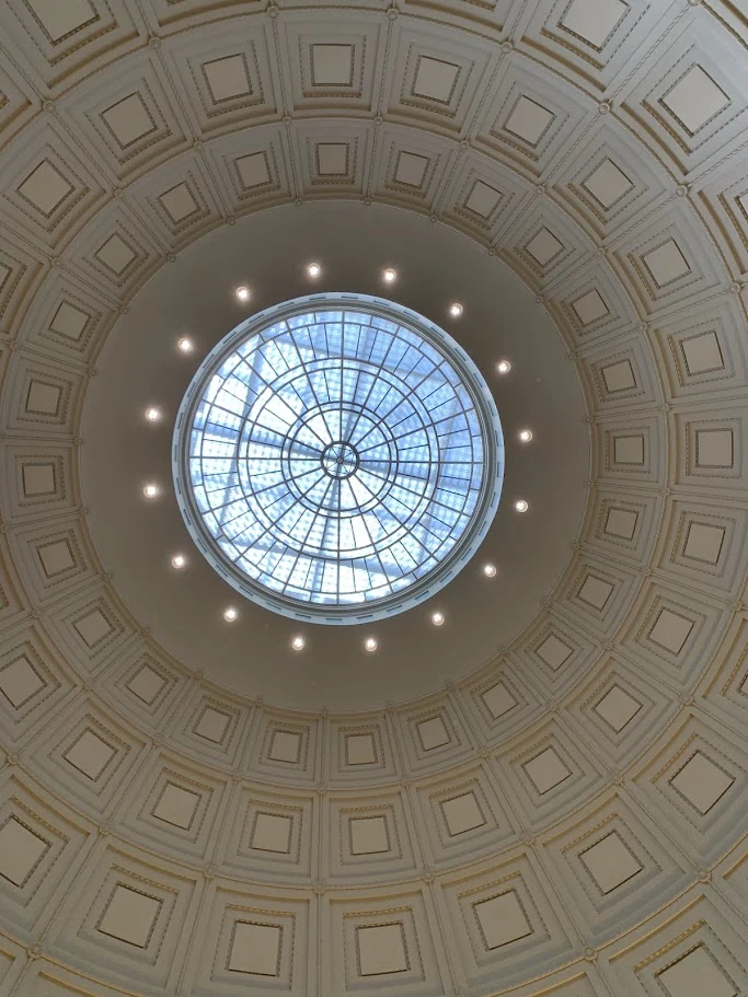 Circular skylight framed by the coffers of an architectural dome