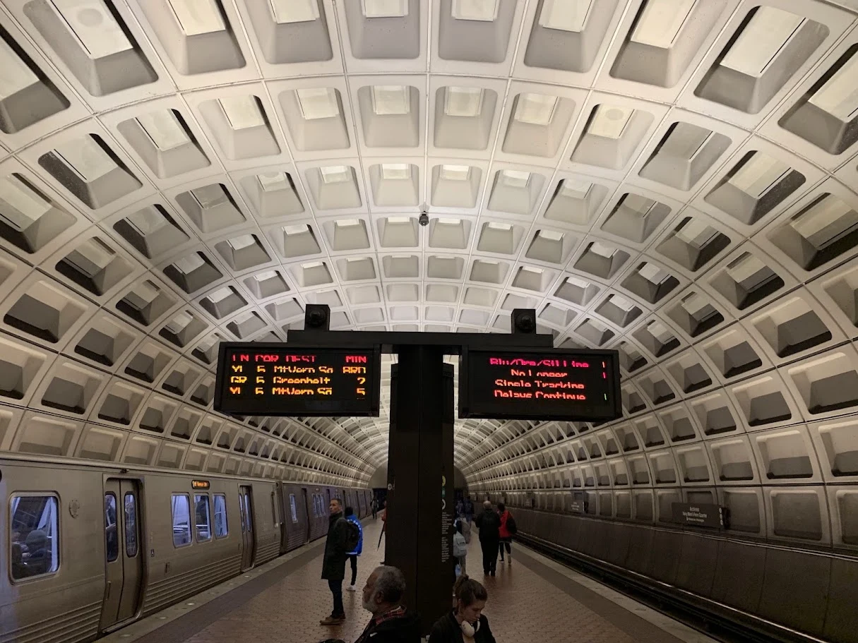 Underground metro platform beneath a coffered vaulted ceiling