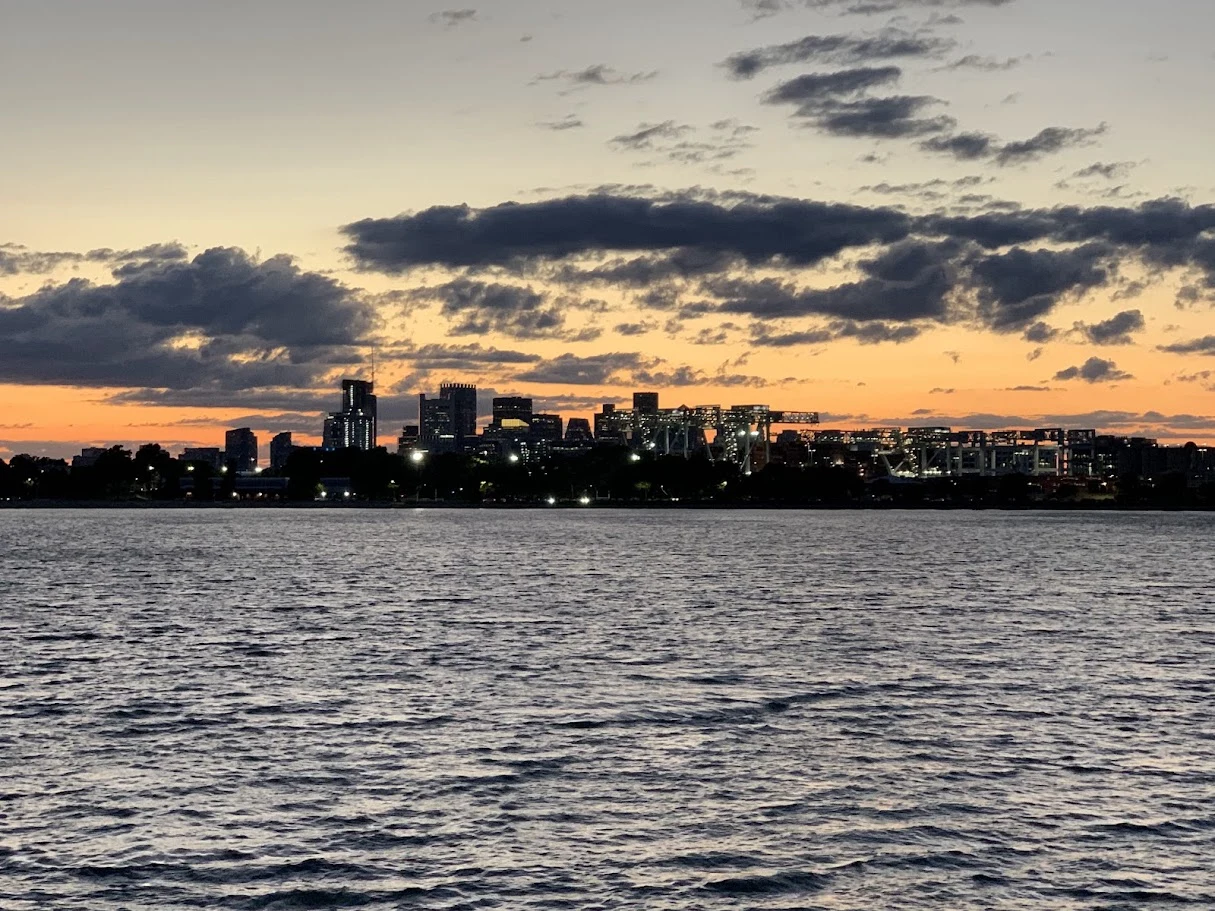 Clouds and sunset light above a waterfront city skyline